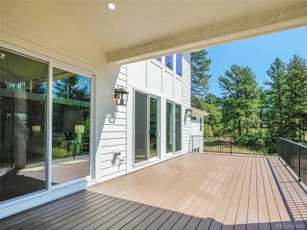 a house with tall trees in the background
