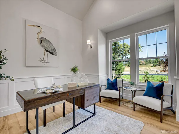 a living room with furniture and large windows