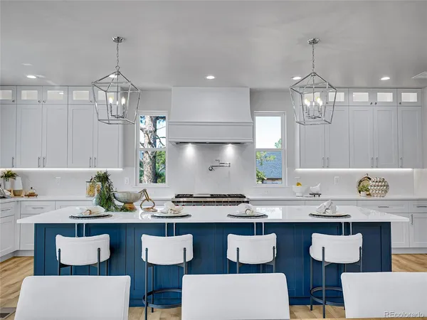 a kitchen with center island table and chairs in it