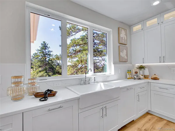 a kitchen with a sink and large window