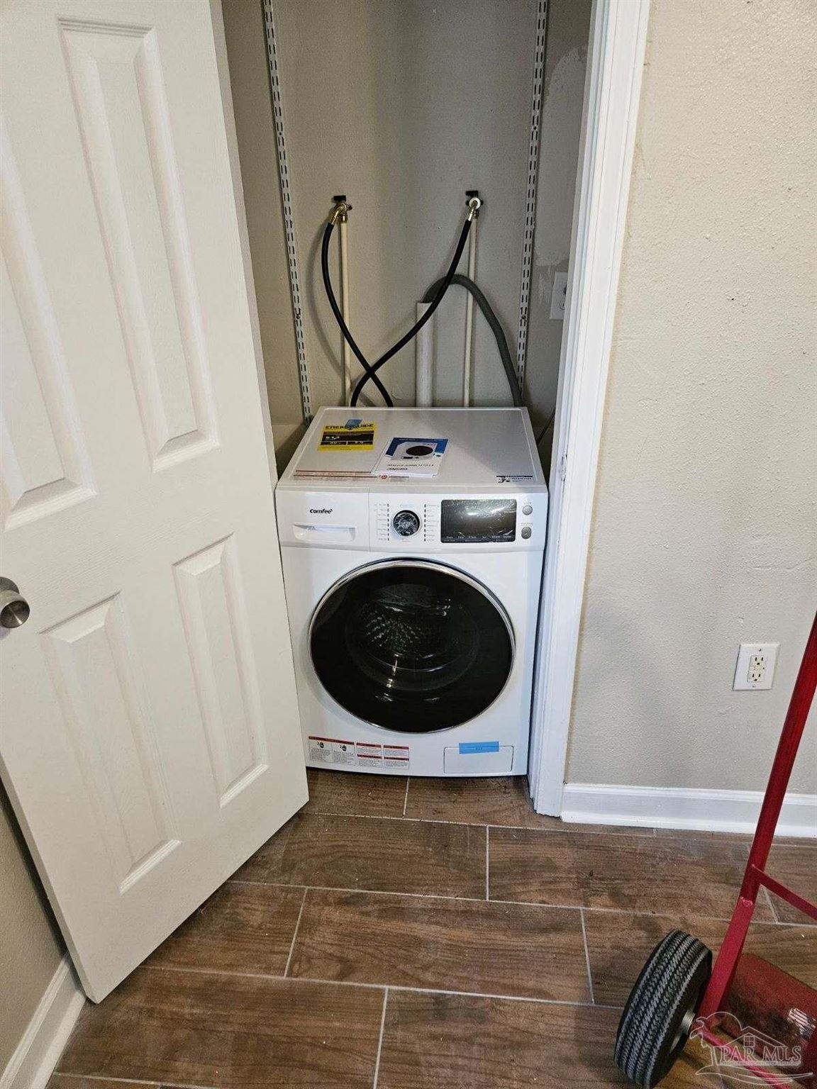 612 McCarroll Road, Unit B Pensacola, FL 32507 - Photo 13 of 13 a view of a storage and utility room with dryer and washer