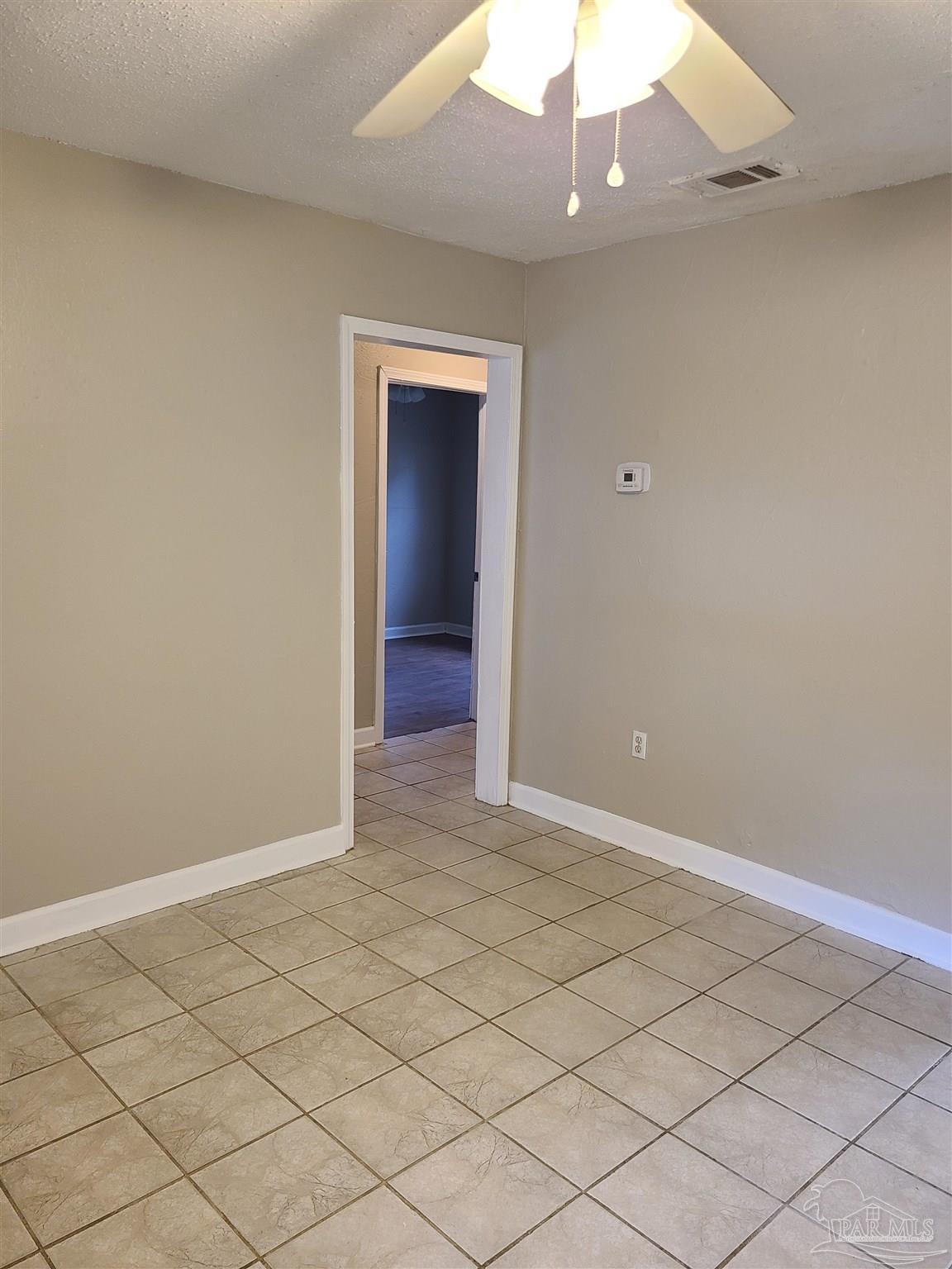 612 McCarroll Road, Unit B Pensacola, FL 32507 - Photo 3 of 13 an empty room with a ceiling fan