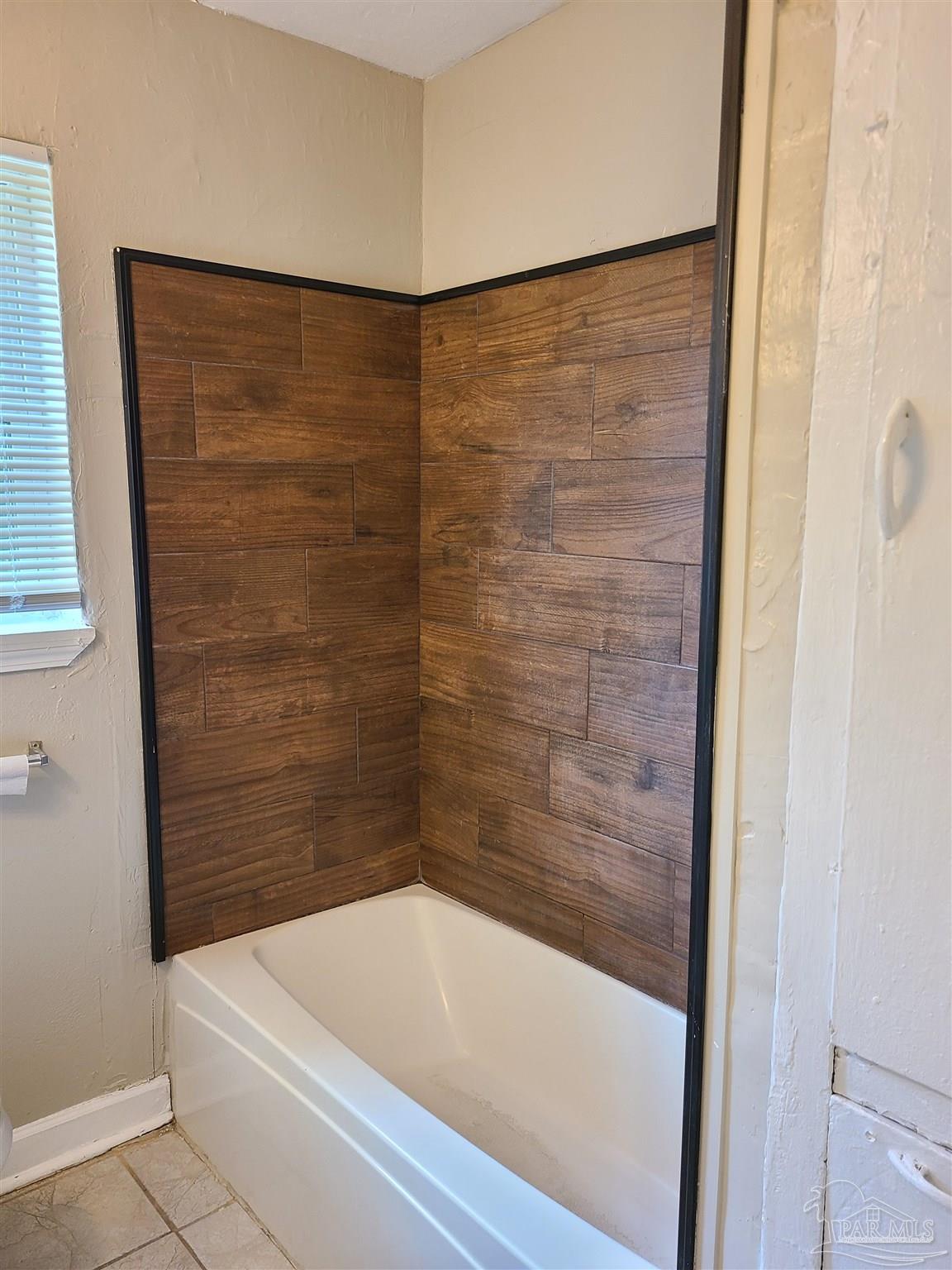 612 McCarroll Road, Unit B Pensacola, FL 32507 - Photo 10 of 13 a bathroom with a shower and a bath tub
