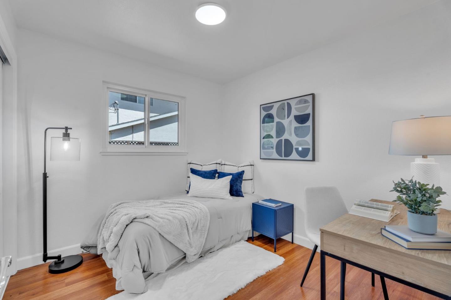 1165 Nadine Drive Campbell, CA 95008 - Photo 22 of 66 a bedroom with a bed and a table in it