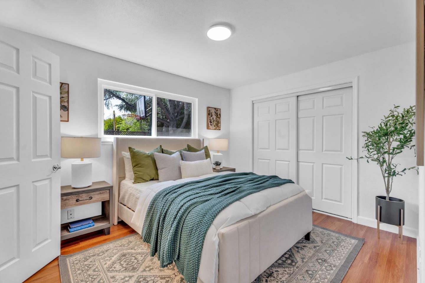 1165 Nadine Drive Campbell, CA 95008 - Photo 29 of 66 a bedroom with bed and a potted plant