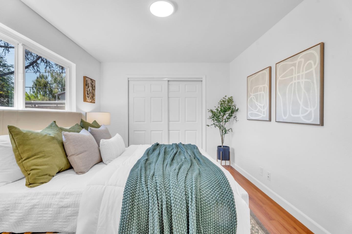 1165 Nadine Drive Campbell, CA 95008 - Photo 30 of 66 a bedroom with a bed and a potted plant