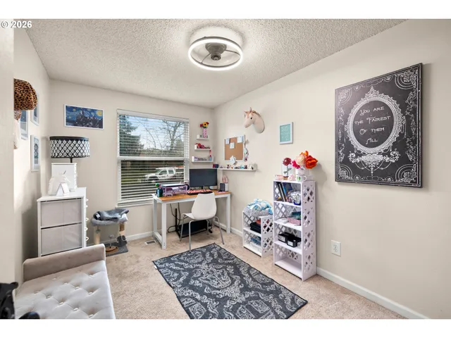 a living room with furniture and paintings on the wall