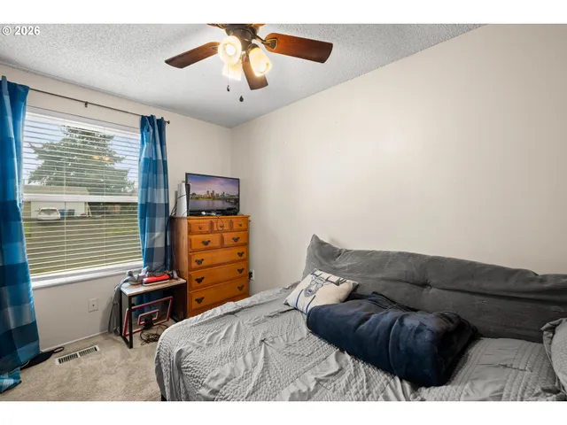 a bedroom with a bed and a television