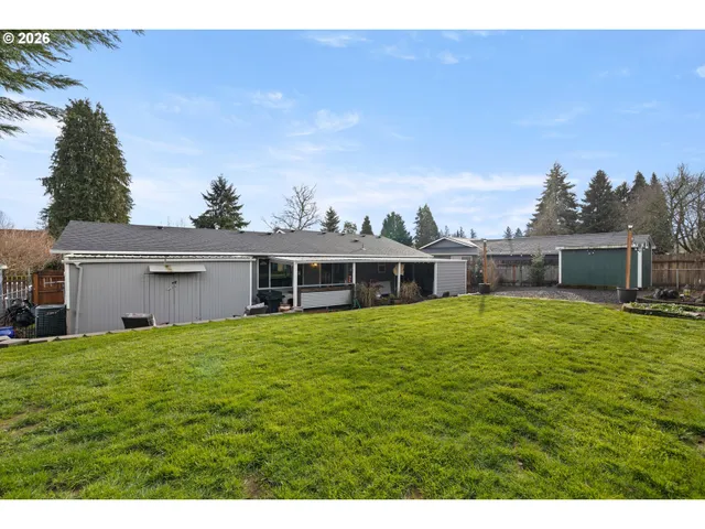 a view of a house with a backyard