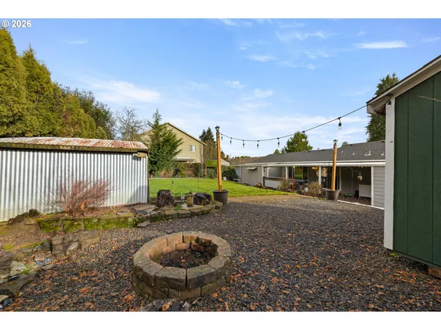 a view of a house with backyard and sitting area
