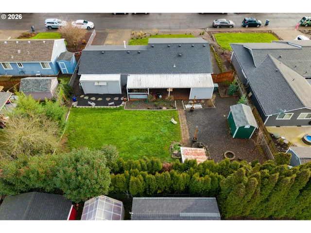an aerial view of a house with a swimming pool yard and outdoor seating