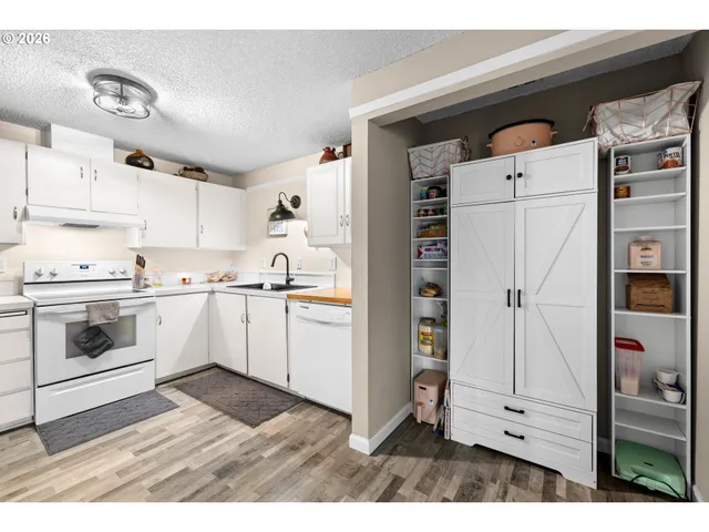 a kitchen with cabinets and white appliances