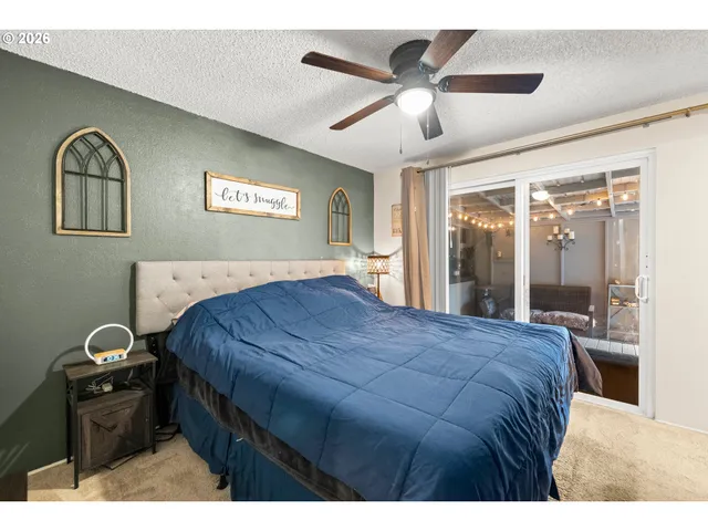 a bedroom with a bed and a large mirror