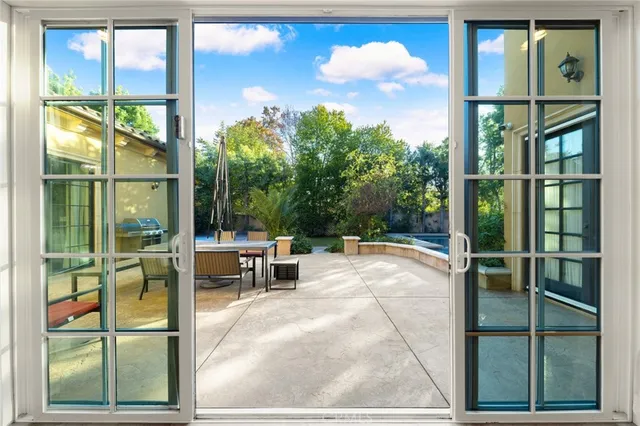 a large white kitchen with a large window appliances and cabinets