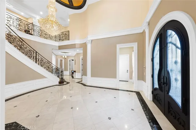 a view of a dining room with furniture and chandelier
