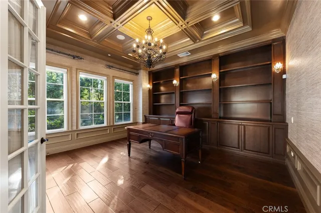 a view of a livingroom with furniture flat screen tv and wooden floor