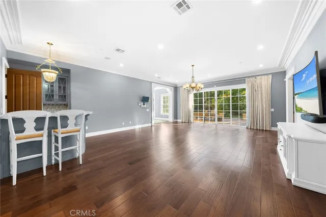 a view of a living room and entryway of a house