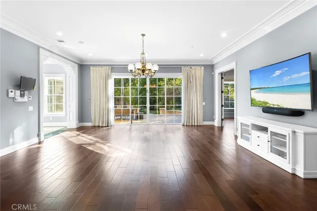a large white kitchen with a large window and stainless steel appliances