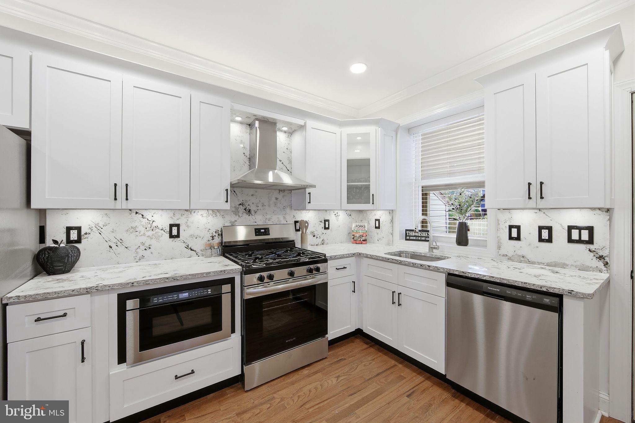 508 Taylor Street Wilmington, DE 19801 - Photo 11 of 46 a kitchen with granite countertop white cabinets and white appliances