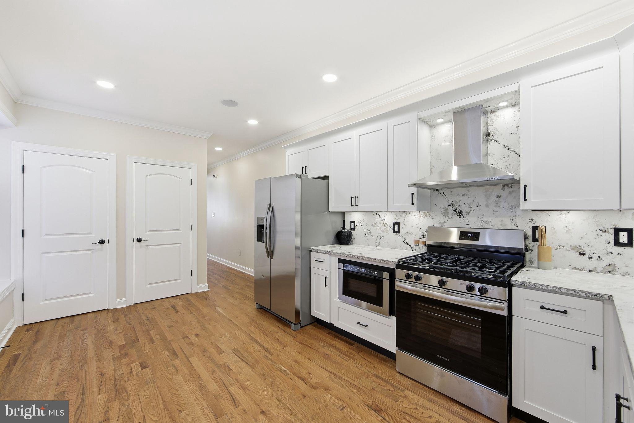 508 Taylor Street Wilmington, DE 19801 - Photo 16 of 46 a kitchen with stainless steel appliances granite countertop a stove and a refrigerator