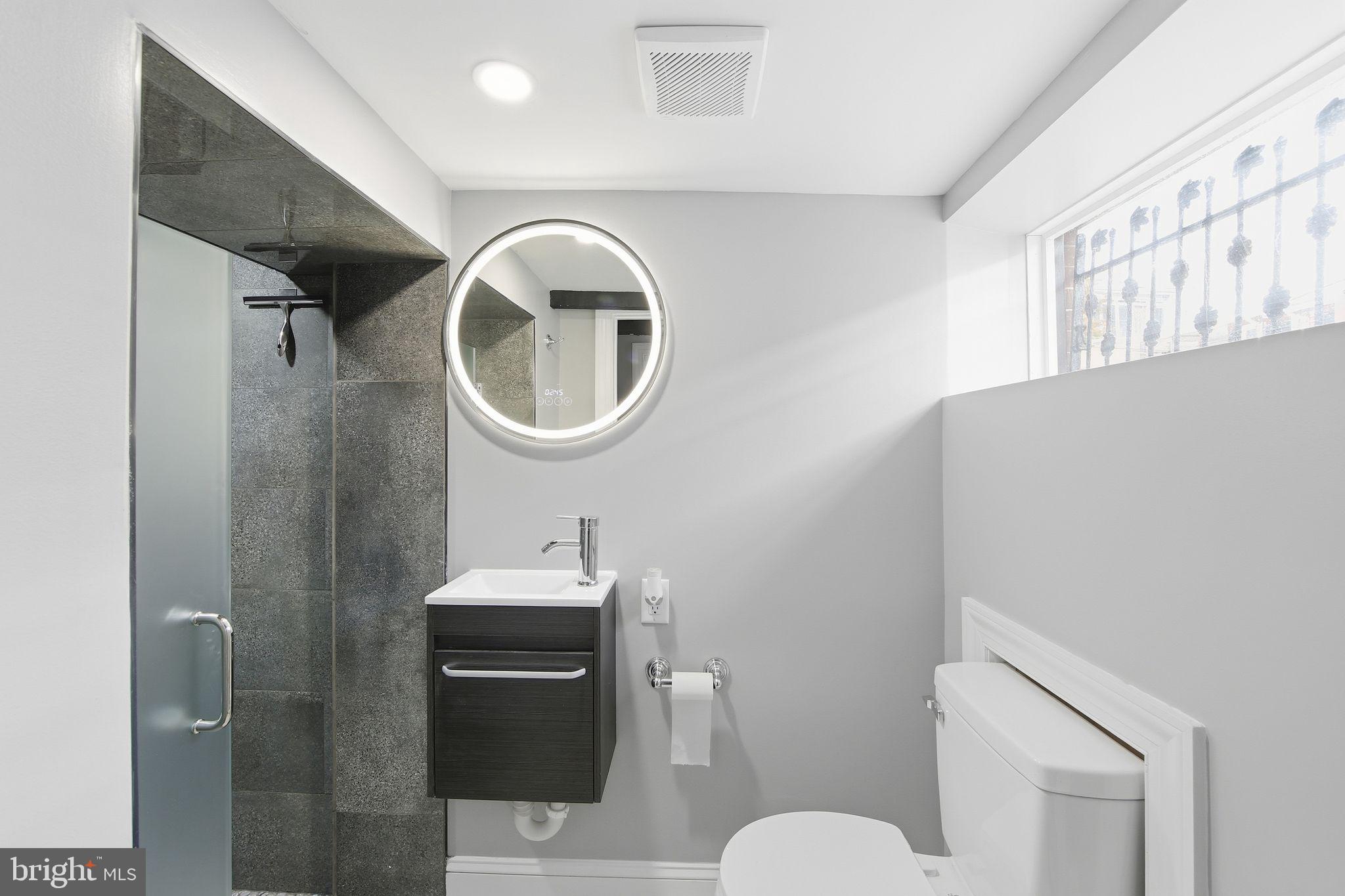 508 Taylor Street Wilmington, DE 19801 - Photo 20 of 46 a bathroom with a sink a toilet and a mirror