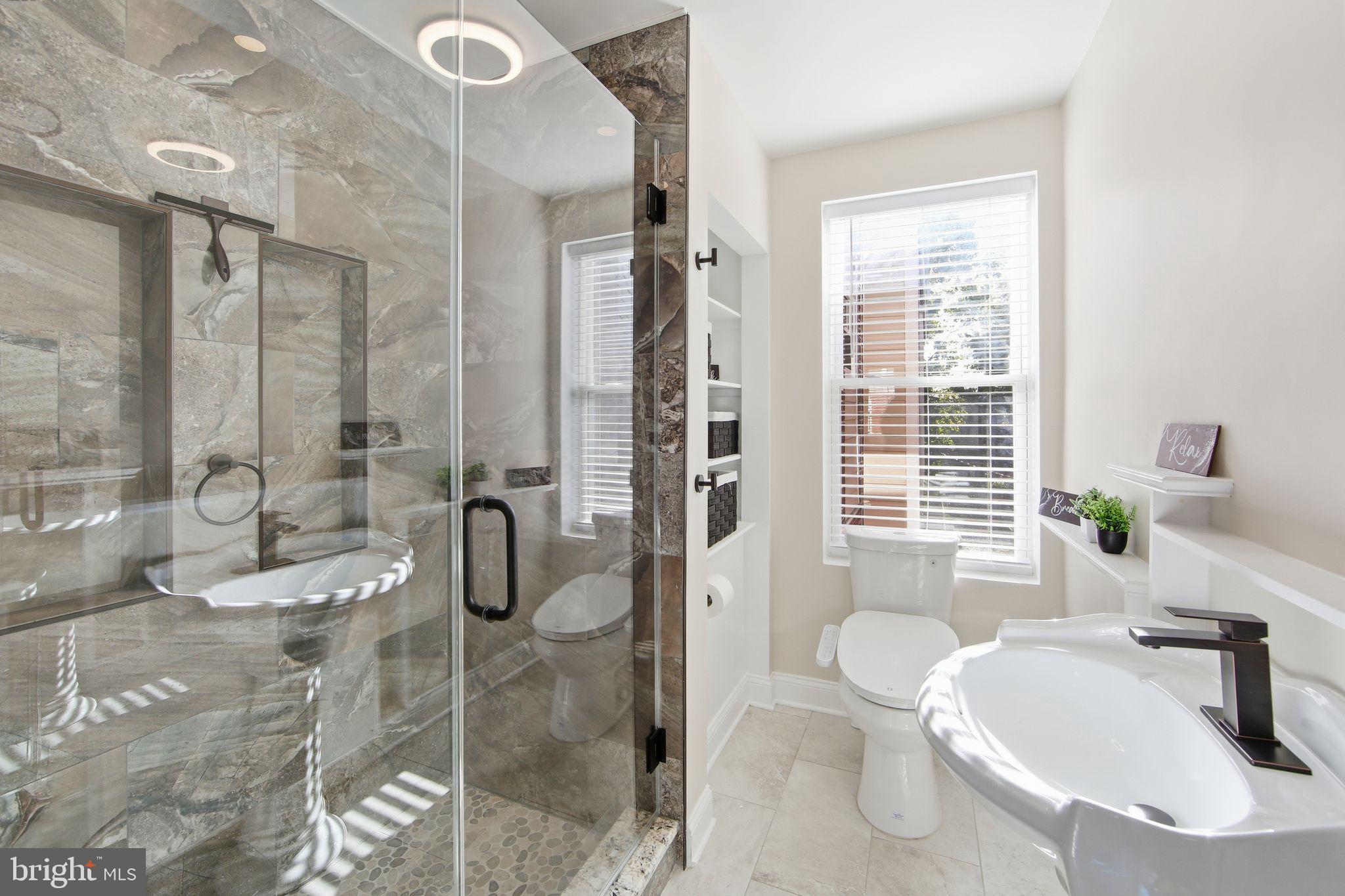 508 Taylor Street Wilmington, DE 19801 - Photo 30 of 46 a bathroom with a granite countertop sink a toilet and shower