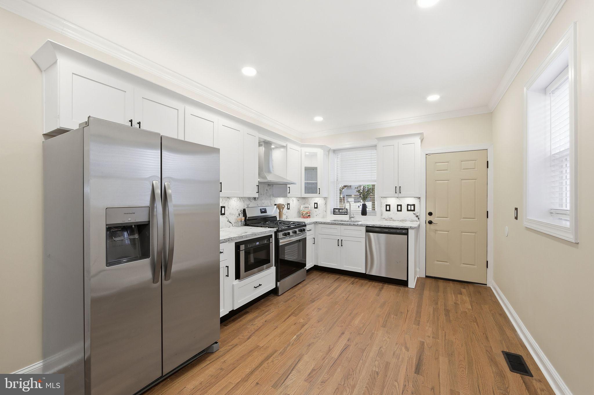 508 Taylor Street Wilmington, DE 19801 - Photo 10 of 46 a kitchen with a white cabinets a stainless steel appliances and wooden floor