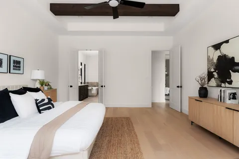 a bedroom with a bed and a flat tv screen