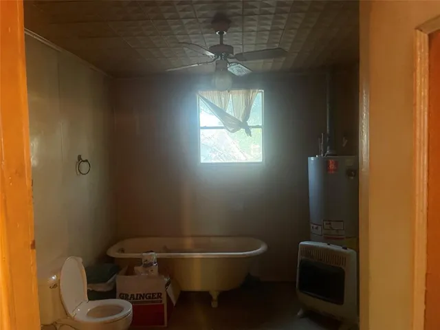 a bathroom with a toilet a sink and mirror