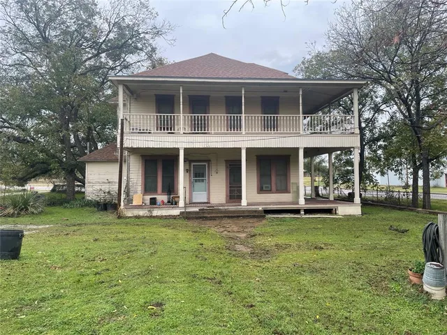 a front view of a house with a garden and porch