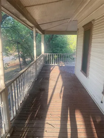 a view of balcony with wooden floor