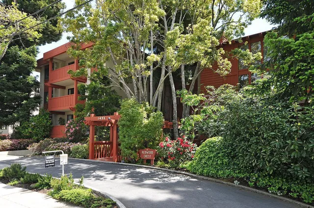 a backyard of a house with lots of green space and fountain