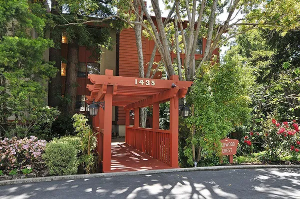 a view of a house with a tree front of house