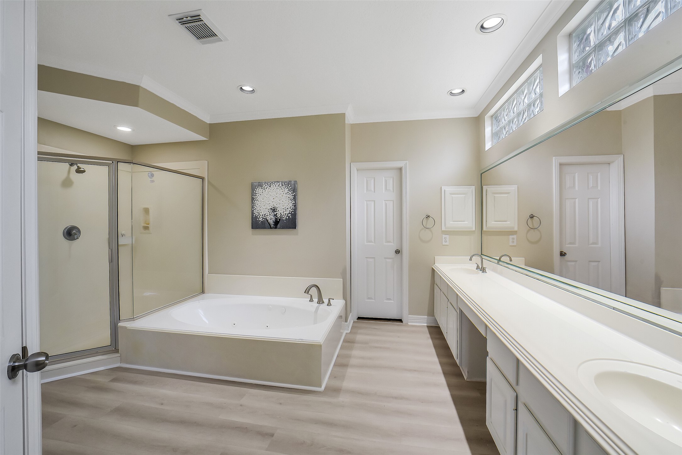 24403 Falcon Point Drive Katy, TX 77494 - Photo 16 of 32 Spa-like primary bathroom featuring a deep soaking tub, separate glass walk-in shower, and dual vanities with ample storage and counter space.