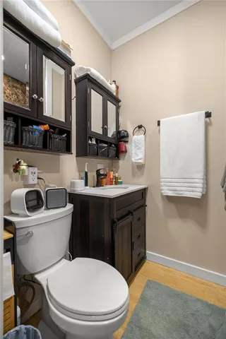 a bathroom with a toilet a sink and a mirror