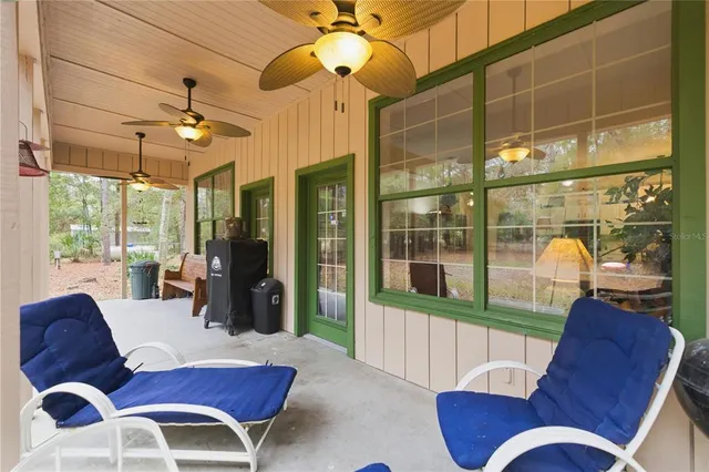 a view of a house with a large tree and yard
