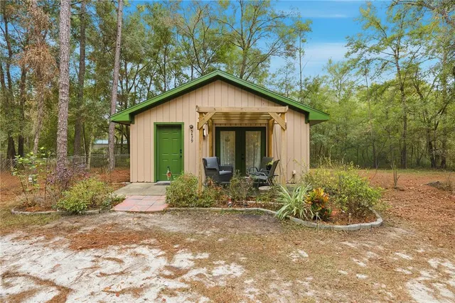 a living room with furniture and a large window with outer view