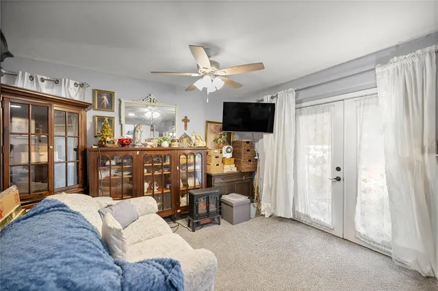 a kitchen with a refrigerator and white cabinets