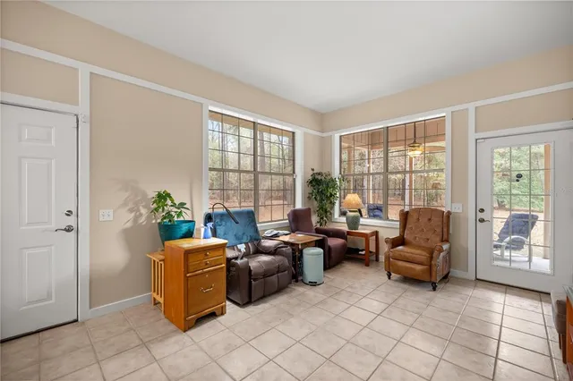 a living room with furniture and a floor to ceiling window