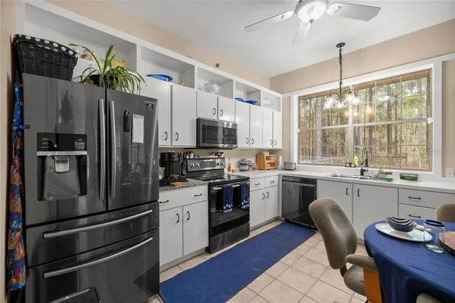 a kitchen with refrigerator cabinets and wooden floor