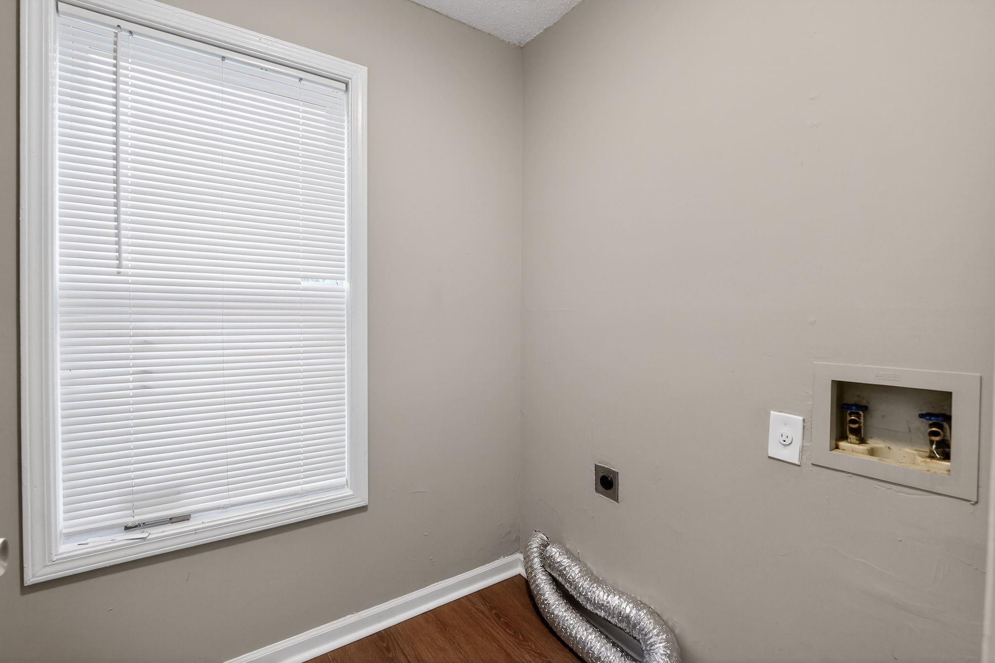 4725 Lofts Road Memphis, TN 38118 - Photo 24 of 32 Laundry room with hookup for an electric dryer, washer hookup, and dark wood finished floors