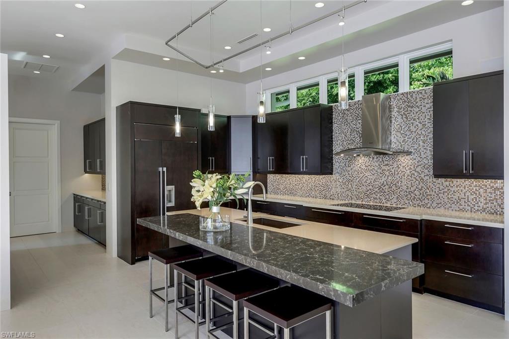 2296 Hawks Ridge Loop Naples, FL 34105 - Photo 14 of 50 Kitchen with subzero refrigerator and view into the butler's pantry.