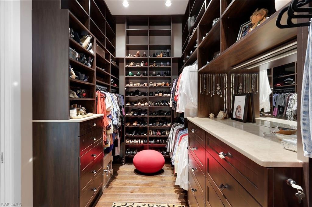 2296 Hawks Ridge Loop Naples, FL 34105 - Photo 27 of 50 First walk-in closet with automatic lighting.