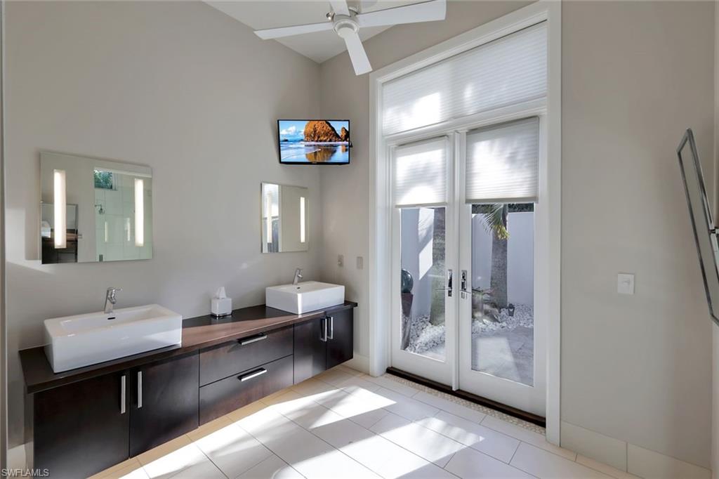 2296 Hawks Ridge Loop Naples, FL 34105 - Photo 28 of 50 Primary bathroom with walkout to private, outdoor shower.