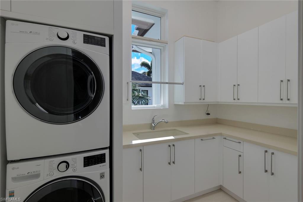 2296 Hawks Ridge Loop Naples, FL 34105 - Photo 33 of 50 Laundry room with new cabinets and washer/dryer