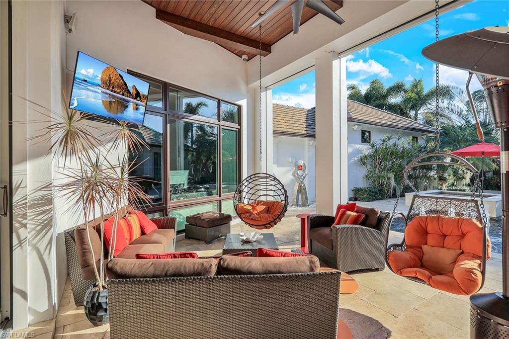 2296 Hawks Ridge Loop Naples, FL 34105 - Photo 34 of 50 Covered lanai with outdoor tv and automated screens and shutters.