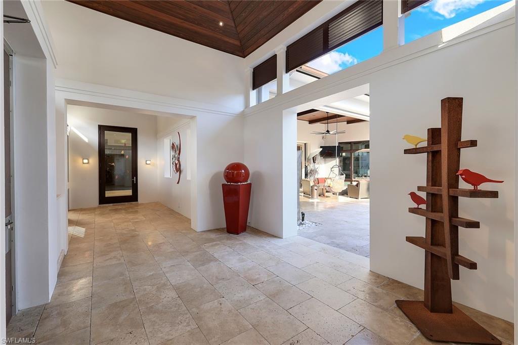 2296 Hawks Ridge Loop Naples, FL 34105 - Photo 6 of 50 Breezeway to the entrance of the home.