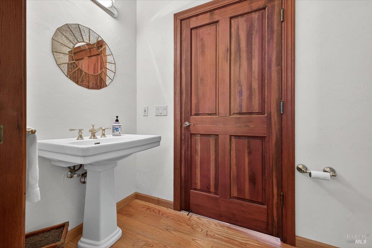 13404 Flora Ranch Road Healdsburg, CA 95448 - Photo 38 of 83 a bathroom with a sink a mirror and a toilet