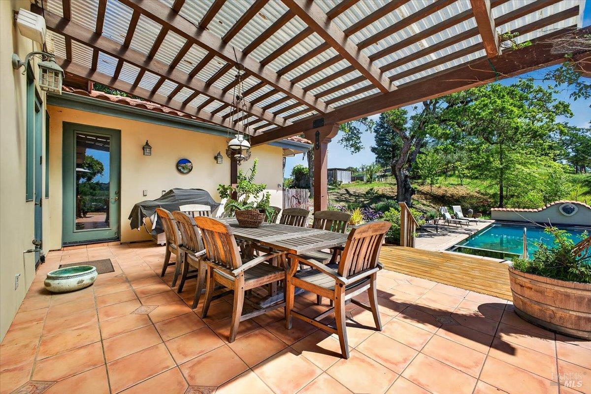 13404 Flora Ranch Road Healdsburg, CA 95448 - Photo 61 of 83 a view of a dinning table and chairs in the patio