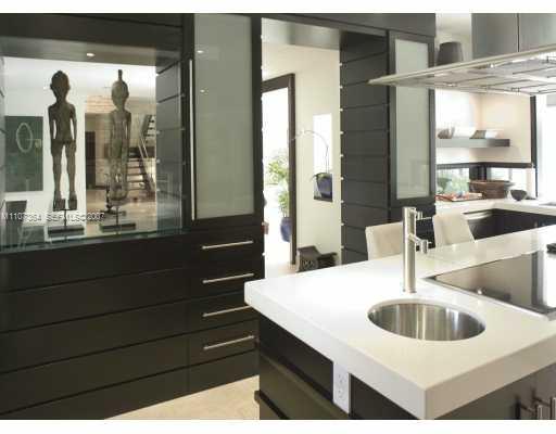 700 Lake Road Miami, FL 33137 - Photo 11 of 12 a kitchen with a sink and a large mirror